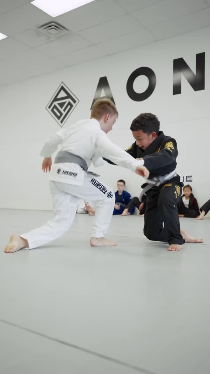 AON Jiu-Jitsu athletes practicing a throw during a training session
